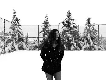 Rear view of woman standing on snow covered landscape