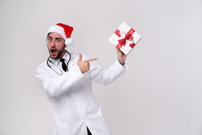 Portrait of man standing against white background