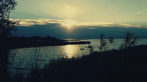 Scenic view of lake against sky during sunset