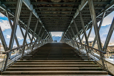 Low angle view of footbridge against sky