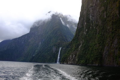 Scenic view of waterfall against sky