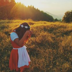 Woman standing on grassy field