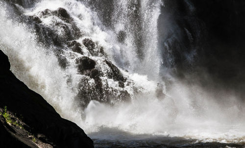 Scenic view of waterfall against sea