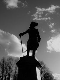 Low angle view of statue against sky