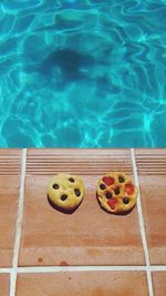 High angle view of focaccia breads at swimming pool during sunny day