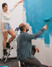 Side view of woman exercising in workshop