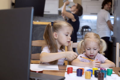 Cute girls drawing at home