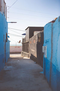 Empty alley amidst buildings in city