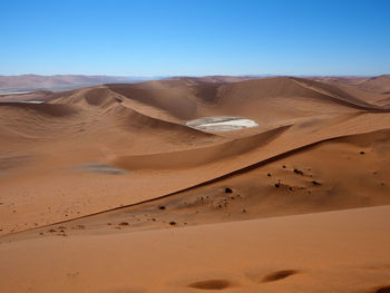 View of desert against blue sky