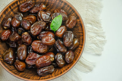 High angle view of roasted coffee beans in bowl