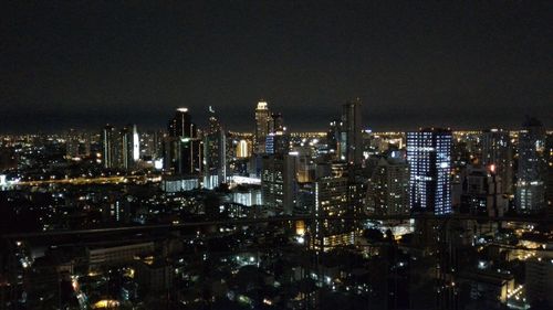 Aerial view of city lit up at night