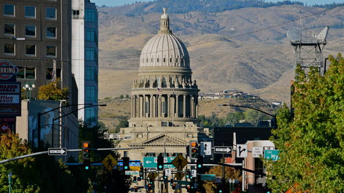 Historic building in city against mountains