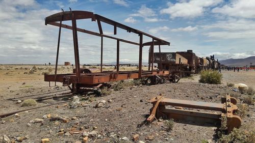 Abandoned train on railroad track against sky