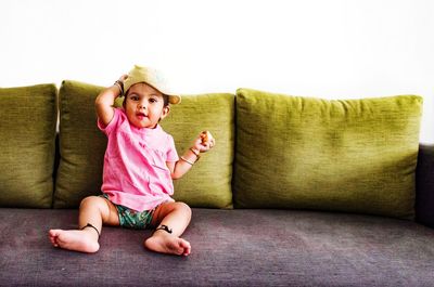 Girl sitting on sofa at home