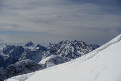 Scenic view of snowcapped mountains against sky