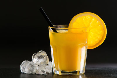 Close-up of drink on table against black background