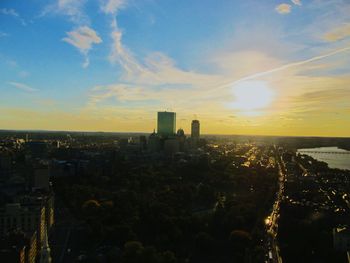 Aerial view of cityscape against sky during sunset