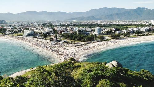 High angle view of sea and buildings in city