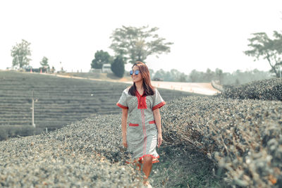 Woman standing on greentea field