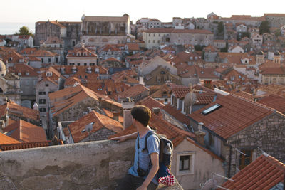 Rear view of people in town against buildings in city