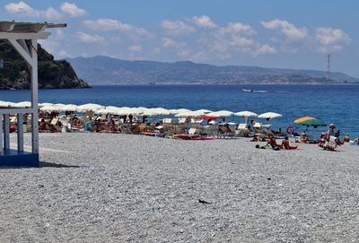 People on beach against sky