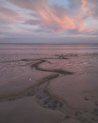 Scenic view of beach against dramatic sky