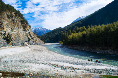 Scenic view of lake by mountains against sky