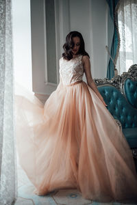 Portrait of young woman with arms outstretched