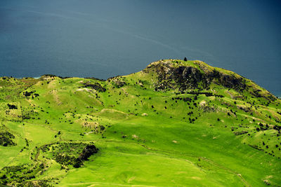 Scenic view of golf course against blue sky