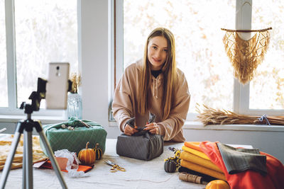 Portrait of woman blogging at home