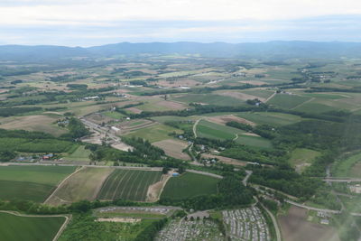 Aerial view of agricultural landscape against sky