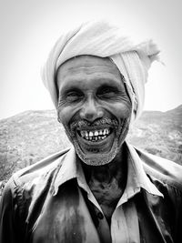 Portrait of cheerful mature man wearing headscarf