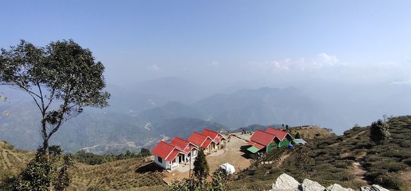 Panoramic view of trees and houses against sky