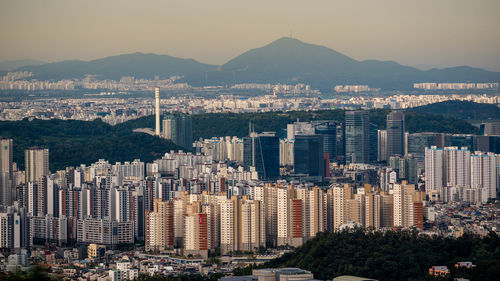 Aerial view of cityscape against sky during sunset