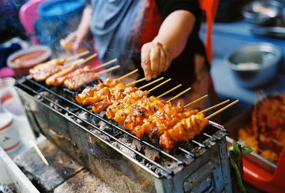 Man preparing food on barbecue grill