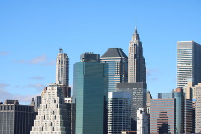 Low angle view of skyscrapers against clear sky