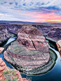 Aerial view of rock formations against cloudy sky