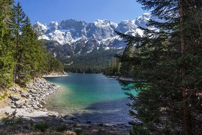 Scenic view of lake and mountains against sky