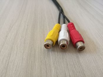 Close-up of colorful rca cables on wooden table