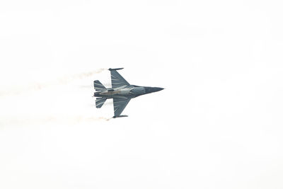 Low angle view of airplane flying against clear sky