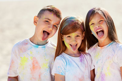 Portrait of smiling kids filthy with powder paint