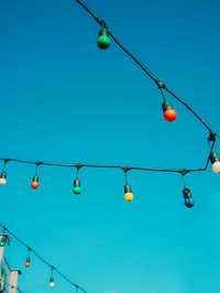 Low angle view of cable against clear blue sky
