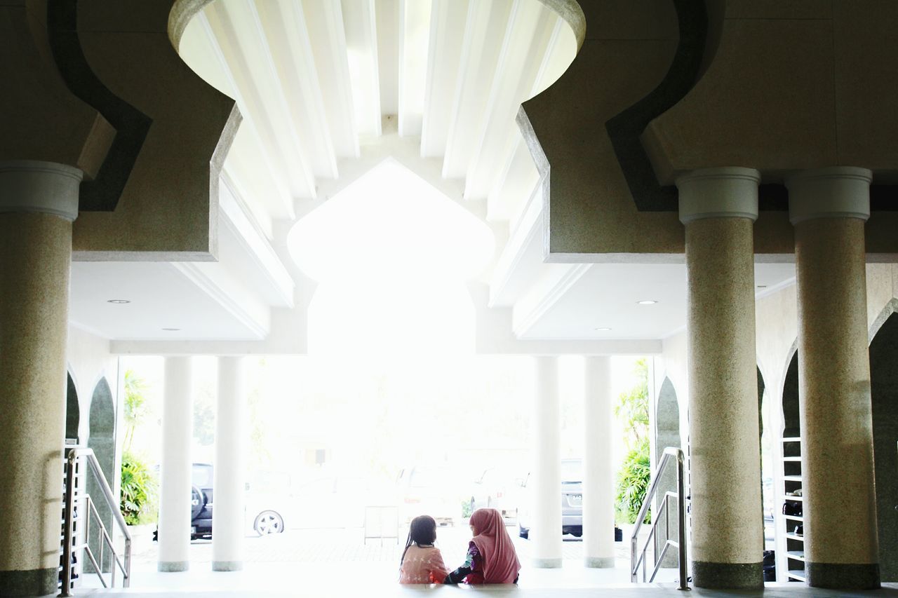 architecture, architectural column, built structure, indoors, column, religion, spirituality, white color, place of worship, railing, arch, corridor, travel destinations, sunlight, person, building exterior, islam, day, famous place