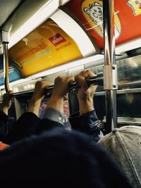 Low section of man sitting in train