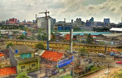 Cityscape against cloudy sky