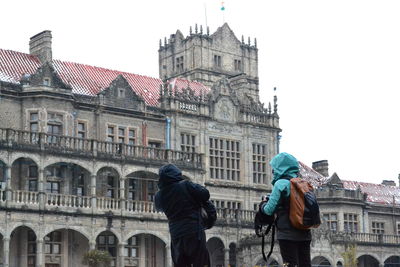 Woman standing in front of building
