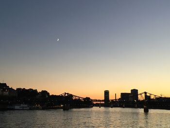 Scenic view of river with buildings in background