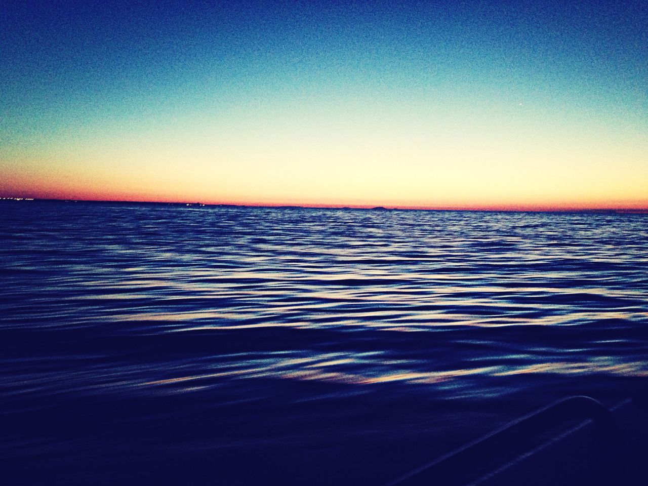 water, clear sky, sea, sunset, scenics, tranquil scene, copy space, blue, beauty in nature, tranquility, rippled, horizon over water, nature, idyllic, waterfront, seascape, orange color, dusk, outdoors, reflection