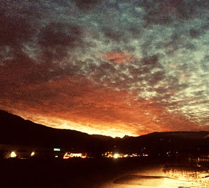 Scenic view of silhouette mountains against sky at sunset