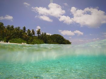 View of calm blue sea against clouds